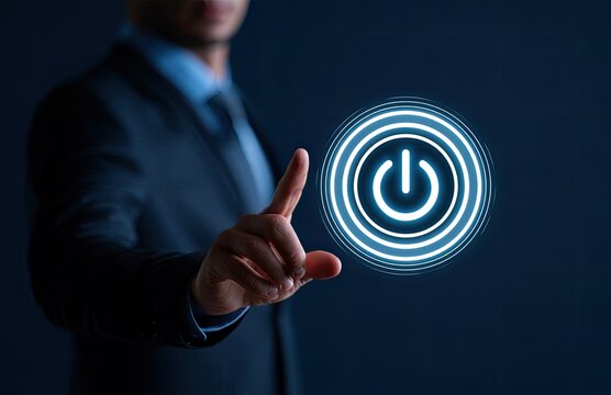 Businessman's hand pointing to a glowing blue power button interface