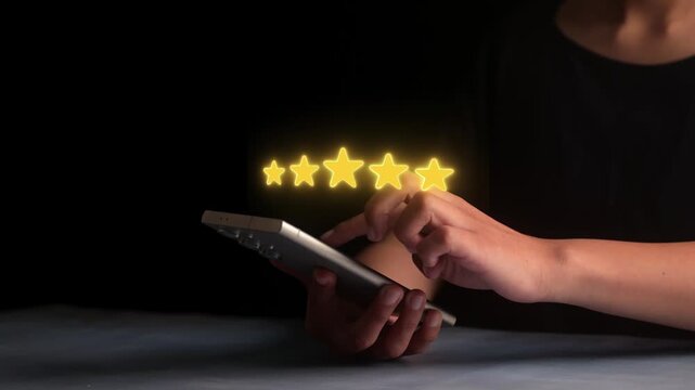 Hands holding smartphone giving 5 star review online, excellent rating and service quality concept