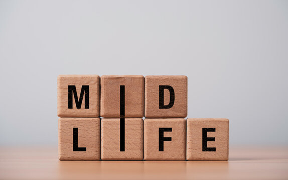 Midlife concept with wooden letter blocks forming MID LIFE, symbolizing middle age, life transition, personal change, aging reflection, new priorities, identity and a fresh stage of adulthood.
