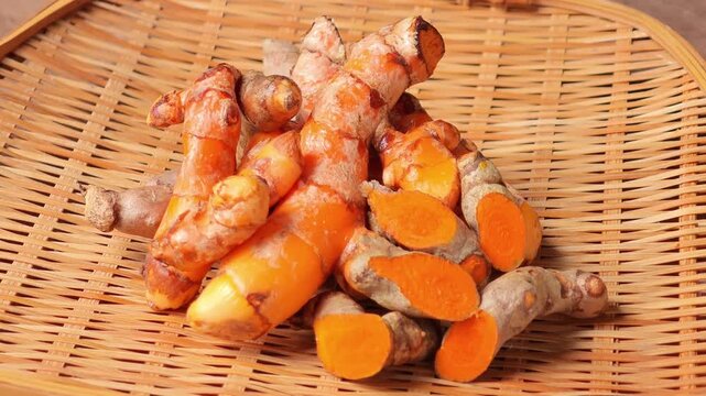 Fresh Turmeric Roots on Bamboo Tray