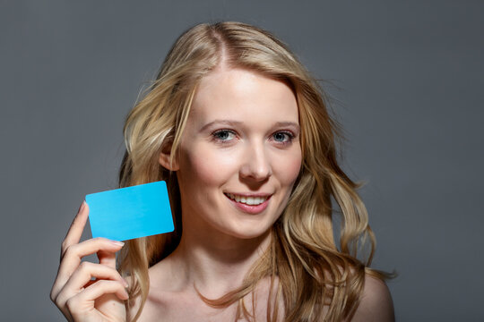 Beautiful Blonde Woman Holding Blank Blue Gift Card