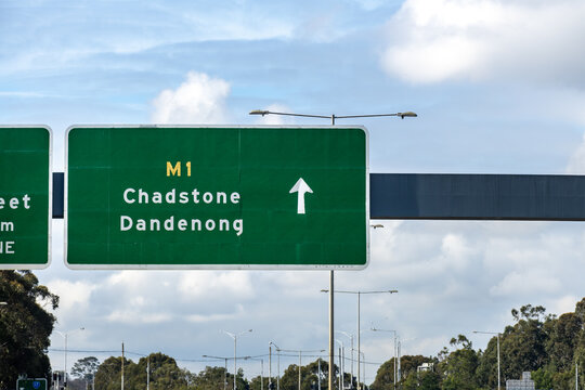 Green overhead freeway directional sign on the M1 Monash Freeway with arrow pointing toward Chadstone and Dandenong&nbsp;in Melbourne, Victoria, Australia.   