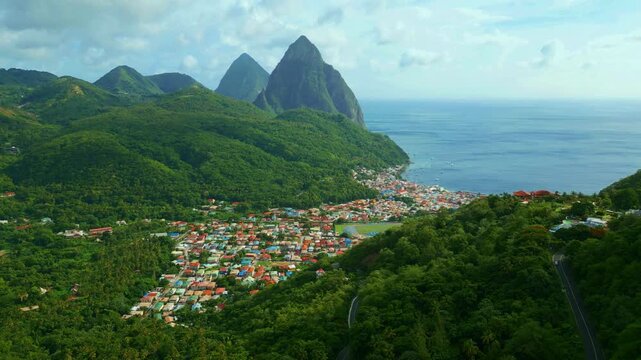 AERIAL SHOT OF SOUFRIERE WITH THE PITONS IN THE BACK ST.LUCIA 4K