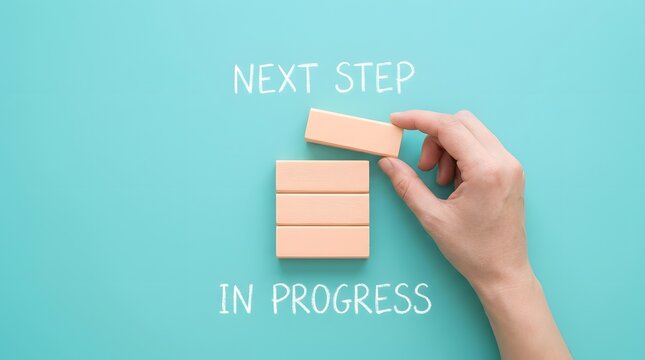A Hand Placing A Wooden Block To Complete A Strategic Progress Tower
