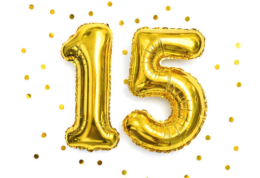 Shiny gold foil number fifteen balloons with confetti celebration elements