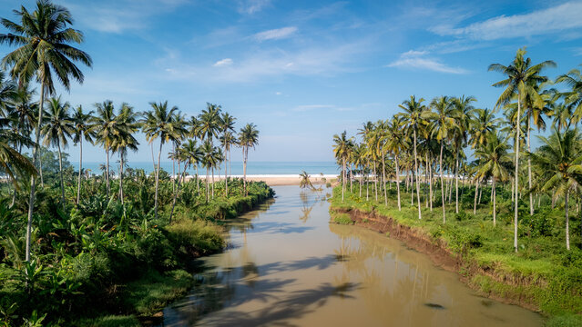 A beach with a river flowing into the sea.
