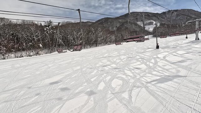 晴天のスキー場のゲレンデとリフトの臨場感ある移動撮影
