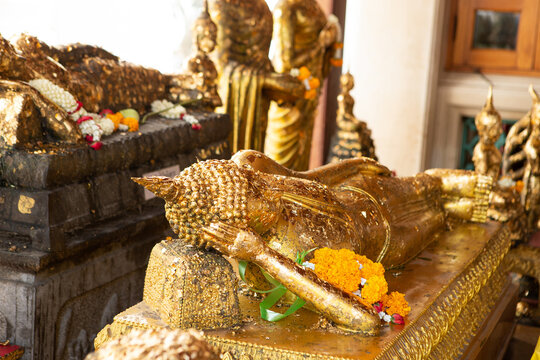 Golden buddha statues and reclining buddha inside Wat Pho temple in Bangkok, Thailand