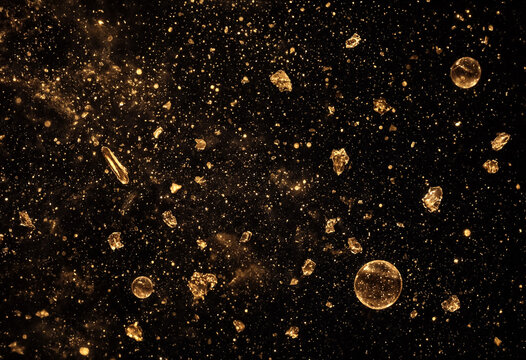 Microscopic view of various crystalline mineral particles under magnification