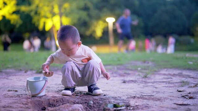 Full-length view of toddler digging hole in park at dusk
