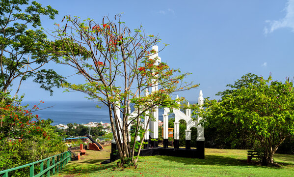 The historic white Morne Bruce Cross overlooking the town of Roseau and the Caribbean Sea in Dominica