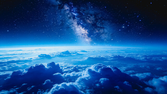 A high-altitude view from above dense cloud layers, showcasing a starry night sky with the Milky Way stretching across the dark expanse above the blue atmospheric horizon.