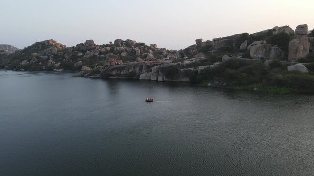 Drone shot of Coracle boat ride in Sanapur lake in Hampi, Karnataka