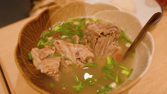 Steaming Hot Thai Spicy Pork Rib Soup in Ceramic Bowl