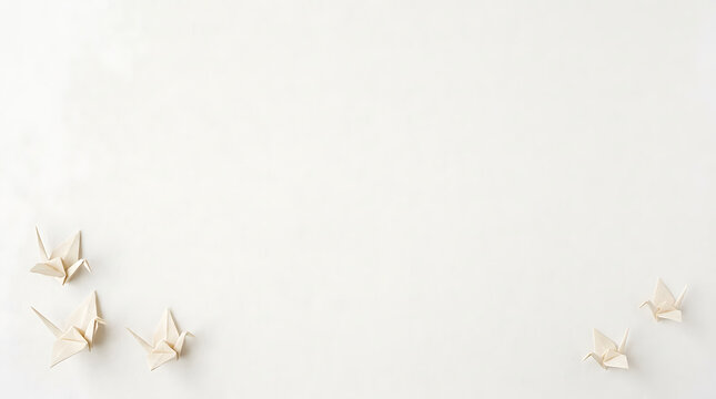 Origami cranes arranged gracefully on a clean white background with ample negative space for creative design and text