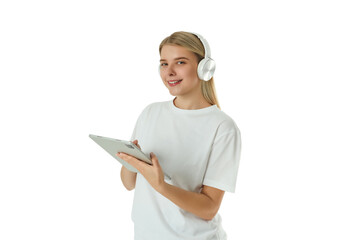 Woman uses tablet and smiles while listening to music. Digital lifestyle concept, PNG © Atlas