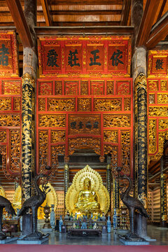 Golden Buddha statue in the Dien Tam The, or The Three Periods Hall, at the Bai Dinh Pagoda in Ninh Binh, Vietnam