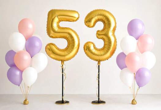 Golden foil number fifty three balloons with pastel colored balloons arrangement