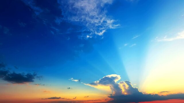 Dramatic Sunset with Sun Rays Breaking Through Clouds in Vibrant Blue and Orange Sky