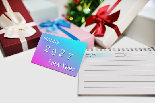 close-up shot, two-tone color of new year card to happy new year 2027 with gift box and christmas background. celebration New Year's Day 2027