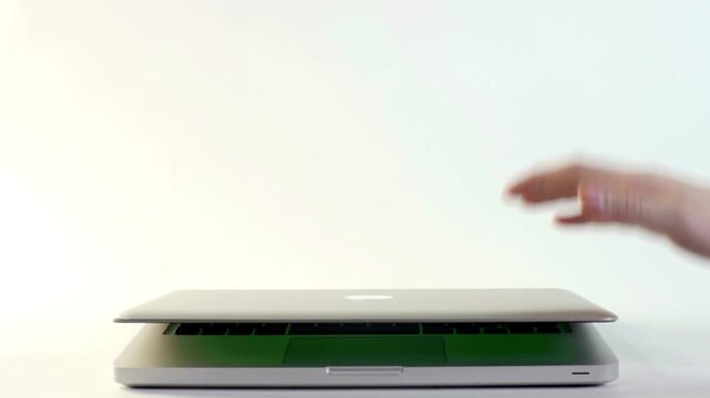 Animated heart particles and a laptop screen with green chroma key for video editing with animations person opening video glowing celebration interaction technology electronic background device