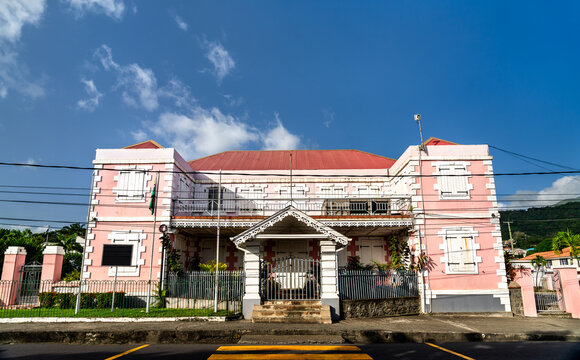 Exterior view of House of Assembly of Dominica on Victoria Street in Roseau under a clear blue sky.