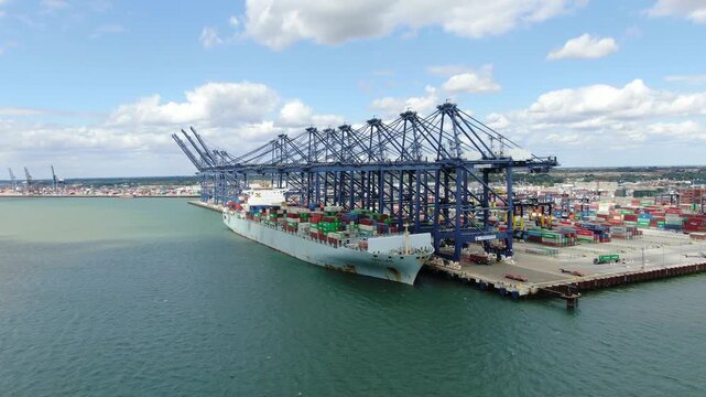 Container moored at Felixstowe loading and unloading Port UK Panning drone aerial
