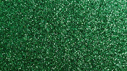 Fototapeta premium Vibrant emerald green glitter texture background featuring sparkling particles and festive holiday decorative shiny surface effect