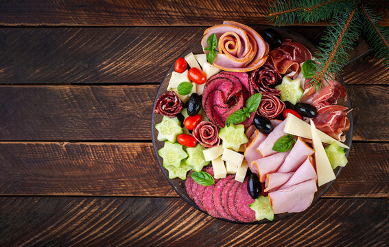 Christmas Charcuterie Board with Cured Meats, Cheese and Fresh Vegetables. Top view
