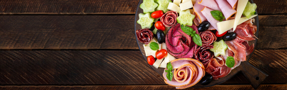 Colorful charcuterie boards and boxes vegetables, meat and cheese.  Assortment of tasty appetizers or antipasti. Top view. Banner