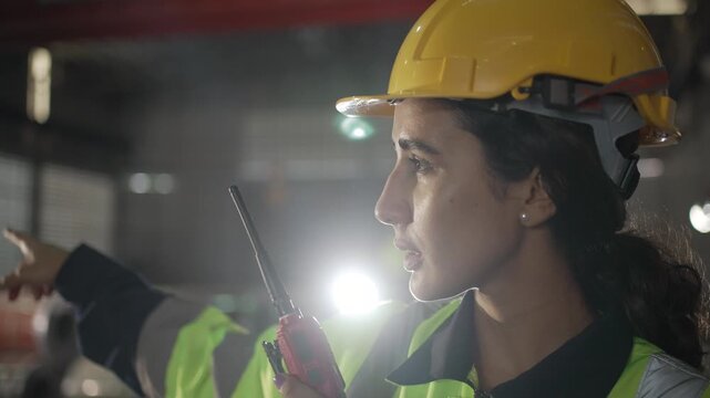 Engineer communicates by radio in industrial plant