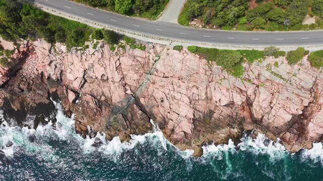 Top down aerial of the rocky Acadia coastline and Park Loop Road
