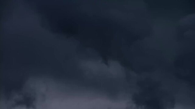 Dark storm clouds rolling across the sky with ominous movement and heavy texture
