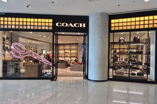 Penang, Malaysia - Sep 06, 2026: Exterior view of Coach luxury fashion boutique store inside a shopping mall showcasing handbags and designer goods