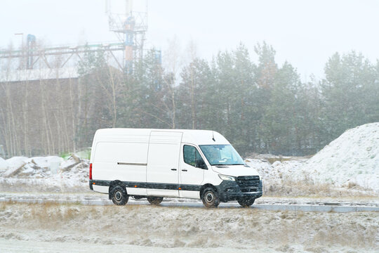 White vehicle transporting goods through snow