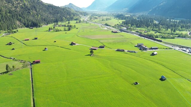 Alpine meadow with high mountain peaks in spring