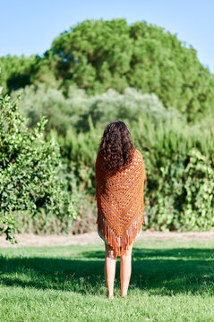 Woman wearing crochet shawl with fringe outdoor