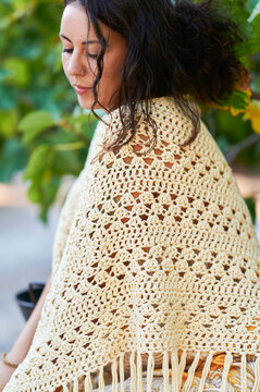 Woman wearing handmade crochet shawl for boho fashion style