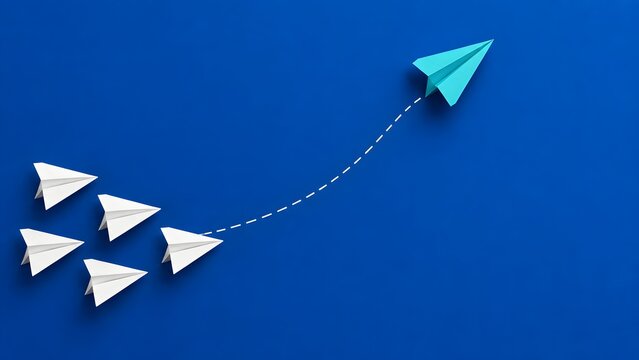Blue paper plane breaking away from the group representing leadership and innovative business strategy