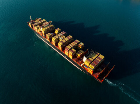 Aerial View Of Container Cargo Ship Navigating Through Deep Blue Ocean Waters Near Si Racha Chon Buri Thailand For Global Logistics And International Freight Trade