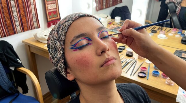 Woman receiving traditional artistic makeup application in studio