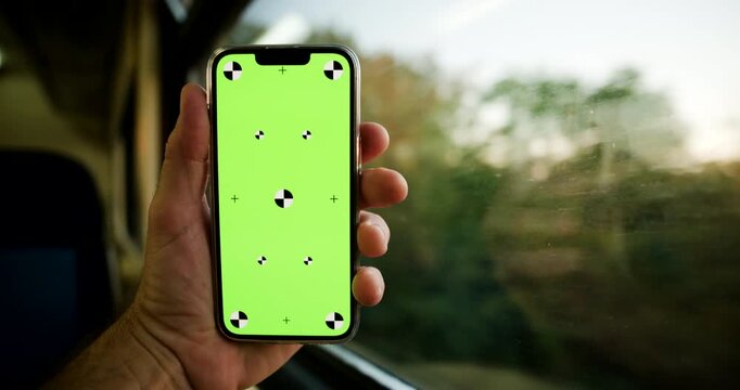 Modern smartphone held inside a train carriage for an online ticket booking concept. Mobile application, railway reservations, digital travel, electronic payments and paperless transportation. 4K.