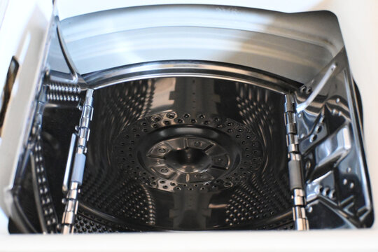 Open empty top-loading washing machine drum