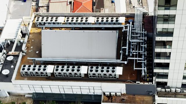 Aerial view of rooftop HVAC units and piping system. 