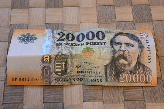20,000 forint banknote on woven wooden surface