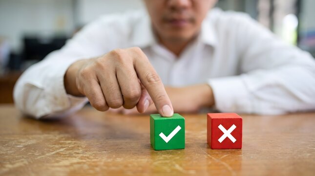 Person choosing between a green check mark and a red cross on wooden blocks