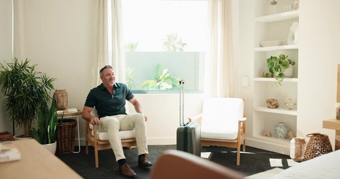 Relax, arrival and man with suitcase at hotel for travel, accommodation and lodge on business trip. Hospitality, mature and person with luggage, thinking or chill for check in, reservation or booking