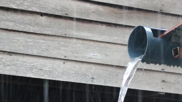 Rainwater Flowing From Roof Drain Pipe During Heavy Rain