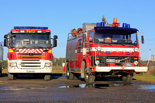 Scania P340 and Volvo F6165 fire trucks parked in a yard. 