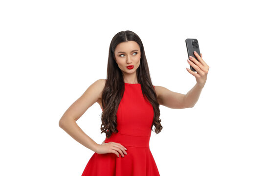 Woman poses for selfie with smartphone in hand, isolated, PNG